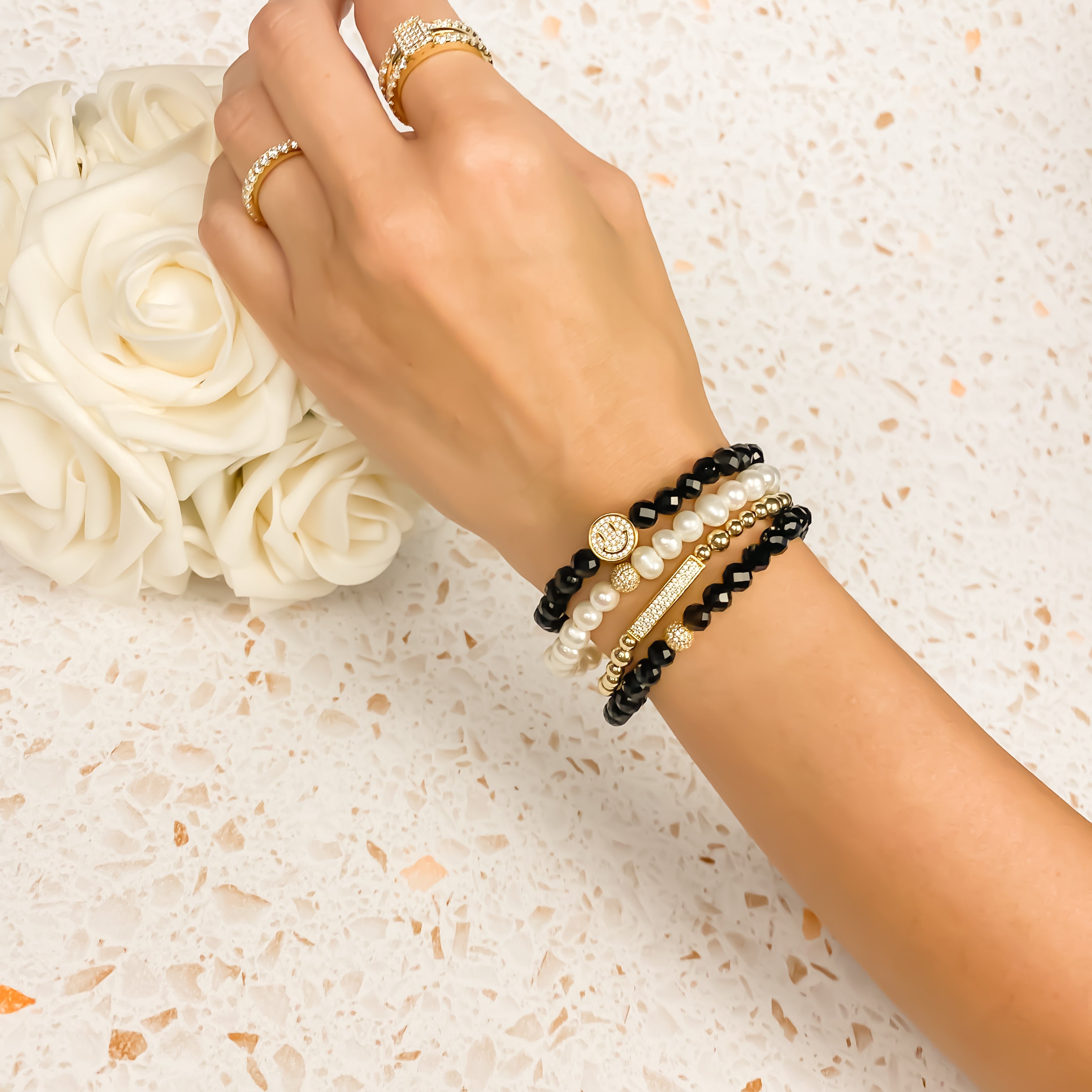 SMILEY FACE ON BLACK ONYX ELASTIC BRACELET