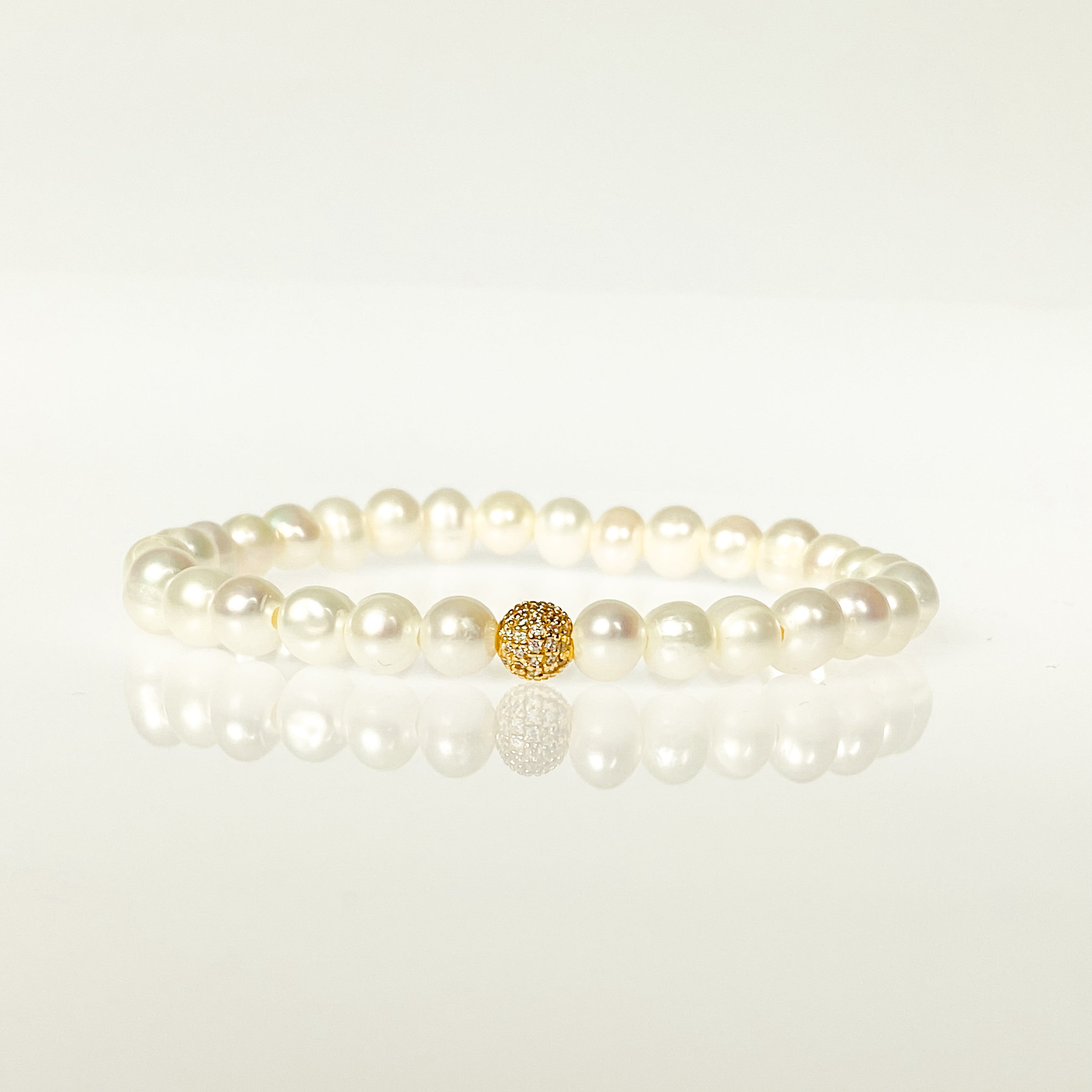 MINI CRYSTAL BALL ON WHITE PEARL ELASTIC BRACELET