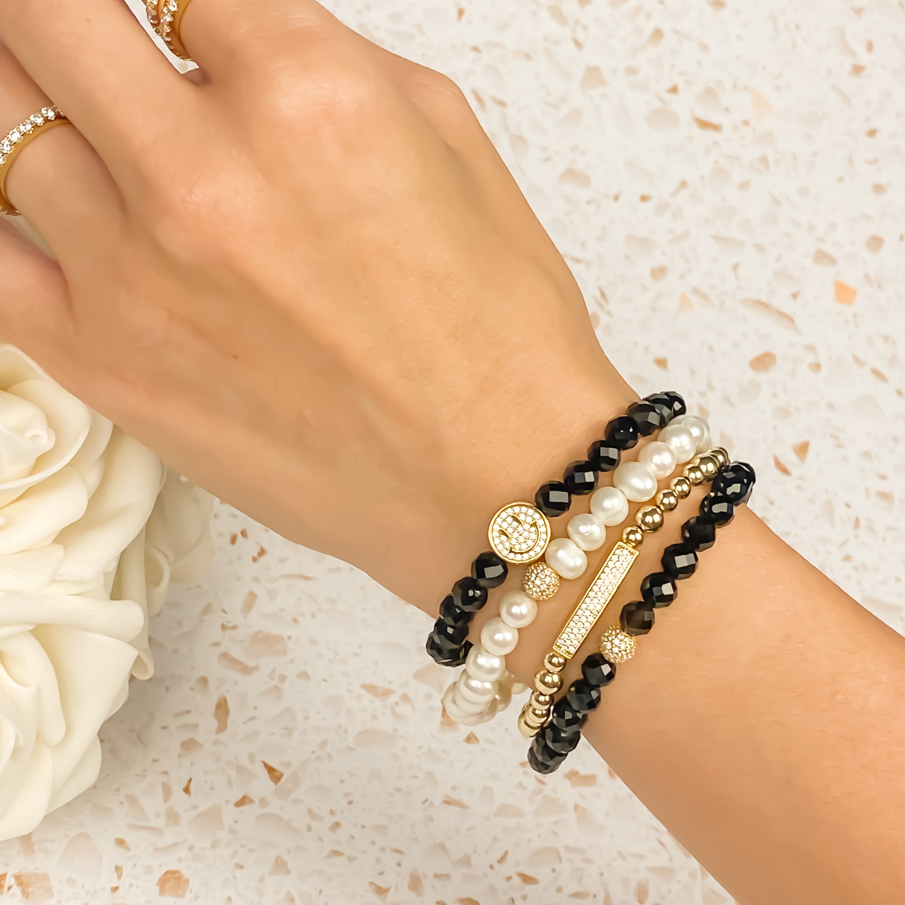 SMILEY FACE ON BLACK ONYX ELASTIC BRACELET